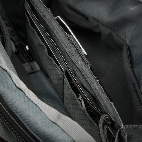 Close-up of the Condor Tech Pouch interior, featuring zippered compartments, pockets, and organized items like cards and a pen—perfect for first responder essentials or shooting range gear.